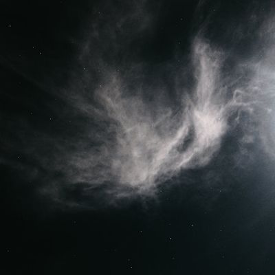 Person taking a deep breath in a tranquil setting.